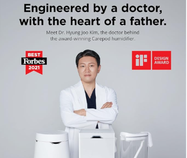 Promotional image showing Dr. Hyung Joo Kim standing behind the CarePod humidifier. Text overlay reads "Engineered by a doctor, with the heart of a father," accompanied by Forbes 2021 and iF Design Award badges