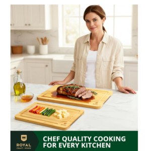 Woman in a bright kitchen using a Royal Craft Wood bamboo cutting board set to serve a juicy roast meat and a side of fresh vegetables and cheese.