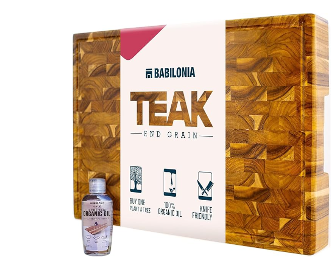 Packaged Babilonia teak end grain cutting board featuring a checkered wood pattern and a bottle of organic conditioning oil.