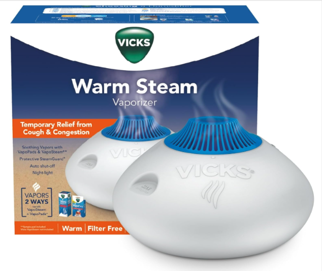 Product packaging for the Vicks Warm Steam Vaporizer, highlighting features like "Temporary Relief from Cough & Congestion," warm steam output, and compatibility with Vicks VapoPads and VapoSteam.
