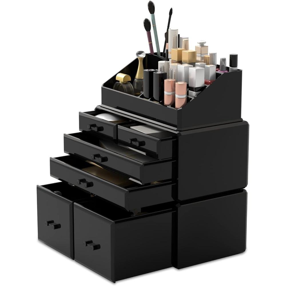 Black acrylic makeup organizer with multiple drawers holding cosmetics, brushes, and beauty products