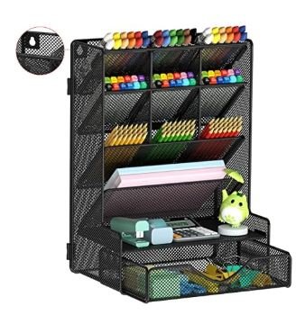 Black metal mesh desk organizer with multiple tiered compartments holding colorful pens, markers, supplies, with bottom drawer and small green owl decoration