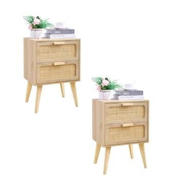 Two natural wood nightstands with woven rattan drawer fronts and angled tapered legs shown styled with books and white flowers on white background