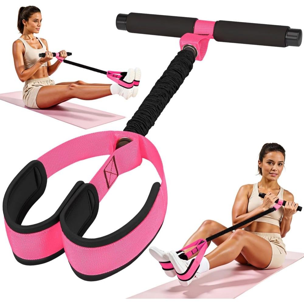 Pink and black portable sit-up assist bar with foot pedal, adjustable resistance bands, foam handles, and suction cup base shown in use for core workout