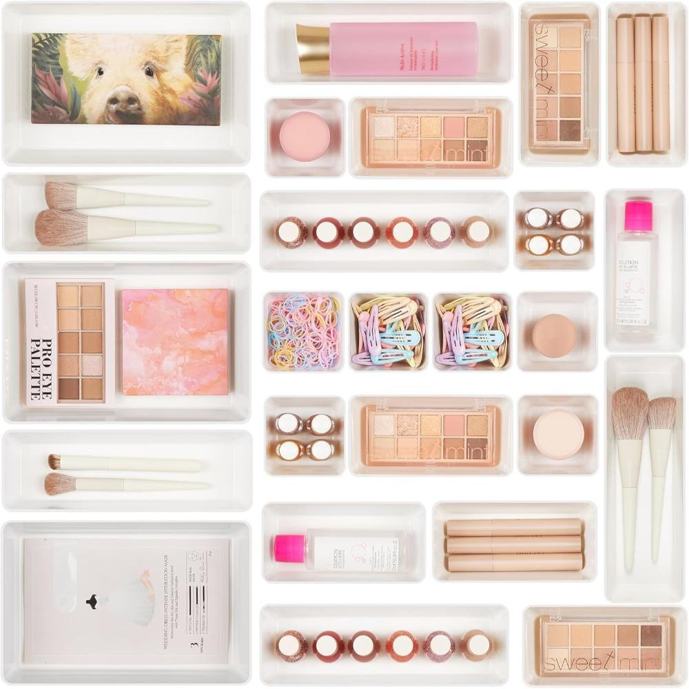 White expandable drawer organizer trays with multiple compartments holding organized makeup, cosmetics, and beauty products