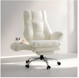 Plush white teddy fleece office chair with channel tufting, adjustable armrests, and chrome rolling base in bright minimalist room with small cat