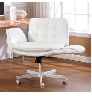 White button-tufted office chair with curved wraparound armrests, padded seat, and silver wheelbase in bright home office with hardwood floors